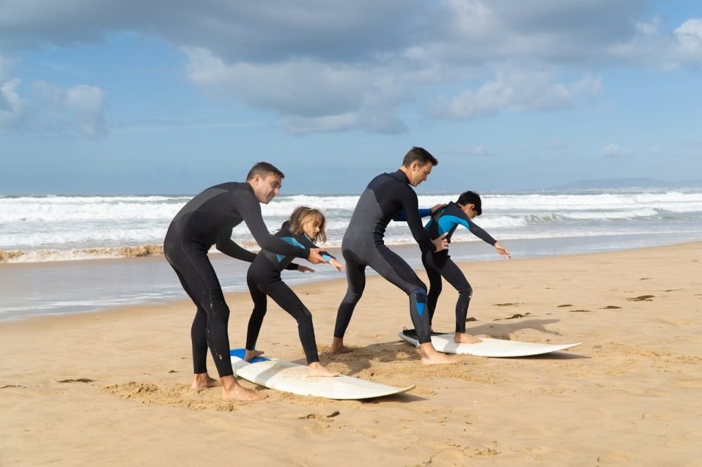 Group learning to surf on a sunny beach in Portugal. Perfect for lifestyle and travel themes.